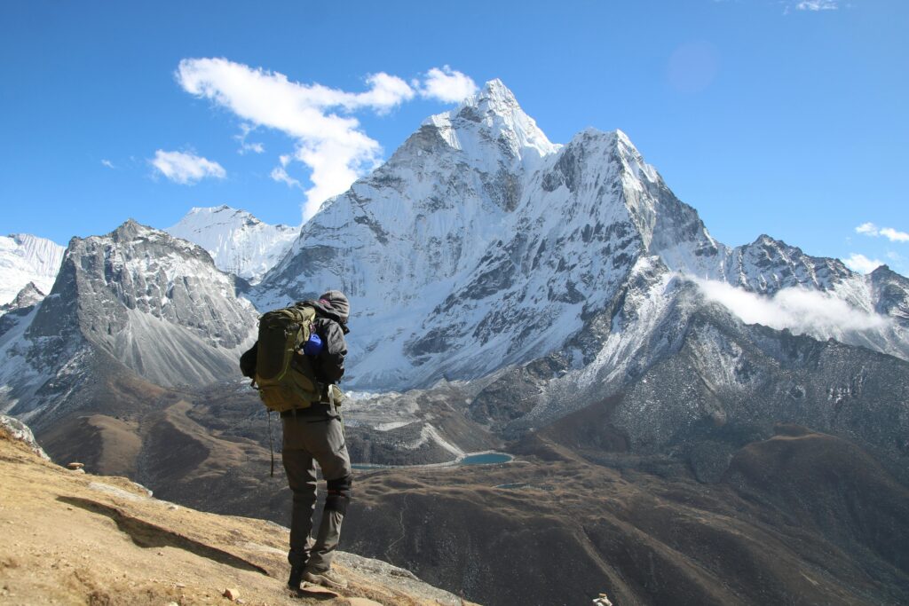 Backpacker exploring the stunning snow-capped mountains in Dingboche, Nepal.